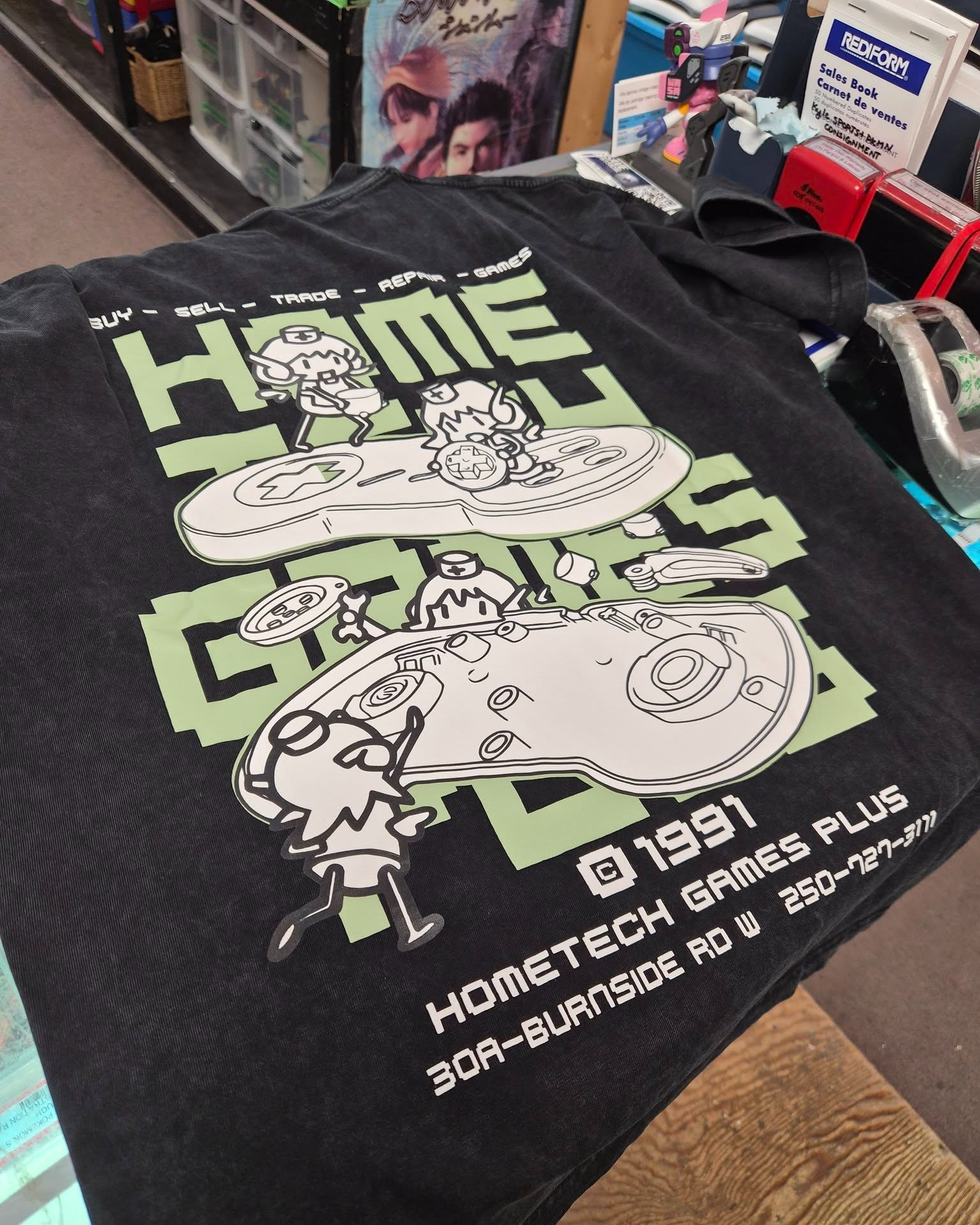 Hometech Games Plus staff modelling shop t-shirts